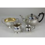 A silver plated three-piece tea set of half reeded form, together with a similar cream jug