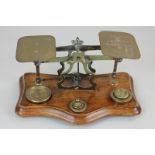A set of brass postal scales with six weights