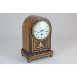 A late 19th century mahogany and brass inlaid mantel clock, the case of domed form, the circular