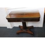A Victorian rosewood card table with rectangular shaped fold-over swivel top, faceted stem on