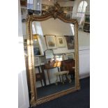 A large 19th century carved giltwood and gesso wall mirror with floral scrolling surmount, 182cm