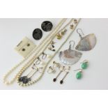 Eleven various pairs of earrings, a cultured pearl necklace, and an imitation pearl necklace