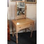 A limed oak dressing table with rectangular mirror over single long carved drawer, on turned legs,