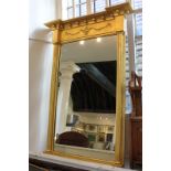 A Regency style giltwood and gesso framed pier glass with ball surmounted break-front pediment and