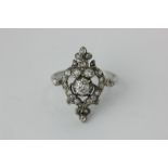 A diamond cluster ring set throughout with mixed old cuts in silver and gold