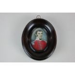 A 19th century miniature portrait on ivory of an officer dressed in red tunic, partial inscribed