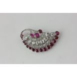 A ruby and diamond brooch set throughout with mixed cut rubies and graduated old and rose cut