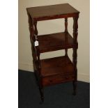 A Victorian rosewood whatnot with single shelf above drawer base, on turned supports to brass caps