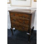 A walnut small chest of three drawers, on cabriole legs, 50cm