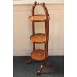 A mahogany three-tier folding cake stand with inlaid bat's wing design