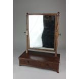 A mahogany framed box base toilet mirror with rectangular mirror plate, the base with two drawers,