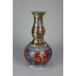 A Chinese porcelain gourd shaped vase with slender neck, decorated with panels of flowers and