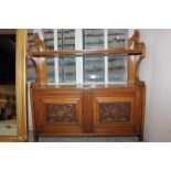 A Victorian hanging wall shelf unit with shelf above two carved panel doors enclosing cupboard,
