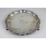 An Edward VII silver salver, makers Mappin & Webb, Sheffield, 1905, of scalloped form on hoof