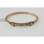 A 15ct gold bangle set with three old cut diamonds, 8.9g gross