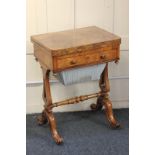 A Victorian walnut sewing / games table, the fold-over rectangular shaped swivel top with inset