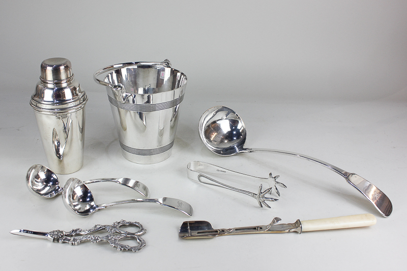 A Harrods silver plated cocktail shaker, an ice bucket, a pair of sauce ladles, a soup ladle, a