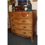 A George III mahogany bow front chest with rosewood cross-banding and ebony line inlay, the two