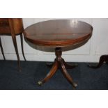 A circular mahogany pedestal occasional table on brass castors, 60cm diameter