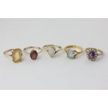 An amethyst and pearl ring, an aquamarine ring, a citrine ring, a garnet ring, and an opal ring