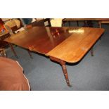 An early 19th century mahogany extending dining table in the manner of Gillows, with rectangular