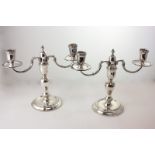 A pair of Elizabeth II silver two-branch candelabra, makers C J Vander Ltd, London 1965 and 1966,