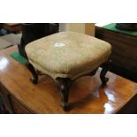 A Victorian small upholstered footstool with square top, on cabriole legs to scroll feet