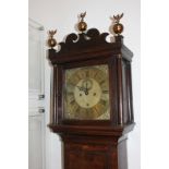A George II oak longcase clock by John Buffett, Colchester, the 12 inch brass dial with scrolling
