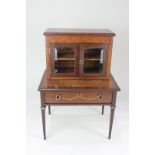 An Edwardian cabinet maker's miniature desk with glazed bookcase top, inlaid with floral and