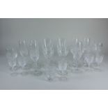 A collection of cut glass drinking glasses comprising a set of six champagne flutes, six various
