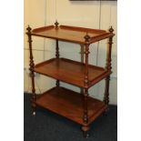 A Victorian walnut and mahogany whatnot, the three shelves on turned supports and castors, 83cm