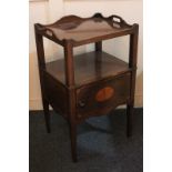 An Edwardian mahogany tray top cupboard with two shelves over inlaid bat's wing panel door, on
