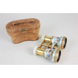 A pair of 19th century opera glasses with mother of pearl eye pieces and focus wheel, on gilt
