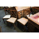 A set of four early 19th century mahogany inlaid dining chairs with pierced bar backs, upholstered