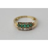 An emerald and diamond two-row ring in 18ct gold