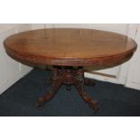 A Victorian walnut inlaid oval loo table with flower decorated tilt-top, on turned supports to