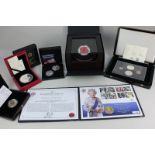 A collection of silver commemorative collectors' coins including a Royal British Legion poppy in
