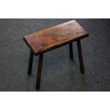 A 19th century rectangular elm stool with long straight legs, 29cm high