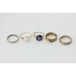 An amethyst and rose diamond ring, a pearl ring, two white sapphire full hoop rings, and a three-