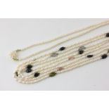 A freshwater pearl long chain strung at intervals with gem stone cabochons, and a freshwater pearl