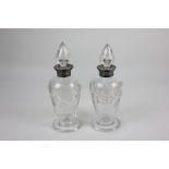 A pair of George V silver mounted cut glass scent bottles with etched flowering branch design,