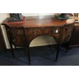 A Regency mahogany bow front sideboard with central drawer flanked by an arrangement of cellarette