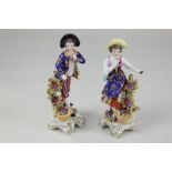 A pair of 19th century porcelain figures of fruit pickers, both with red anchor mark verso, 16cm