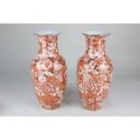 A pair of Japanese porcelain baluster vases with rust coloured floral decoration on gilt coloured