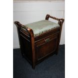 A Victorian stained mahogany piano stool with green studded upholstered top and music drawer