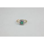 An emerald and diamond ring, the step cut stone in a border of ten eight-cut diamonds