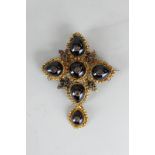 A 19th century garnet brooch set with six round and pear cabochons set with a tiny rose cut