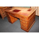 A large Victorian pedestal desk, the rectangular shaped top with red leather inset, above an