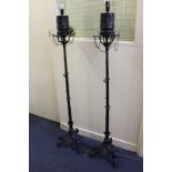 A pair of 19th century bronze neo classical standard lamps converted from oil lamps, each with top