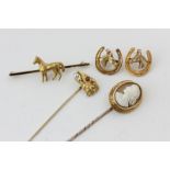 A 14ct gold, pearl and ruby eagle head stick pin, a shell cameo stick pin, a pair of horse head